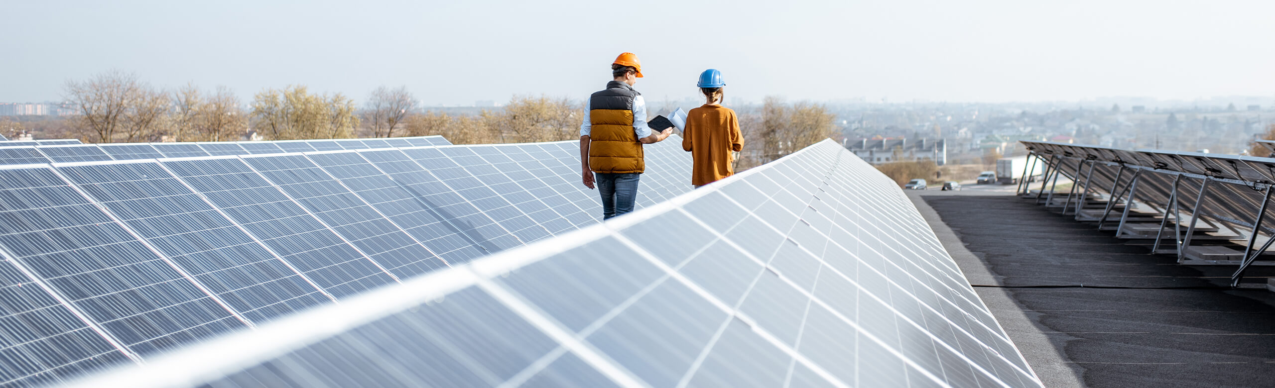 REGUPOL construction Individuals working in construction as they walk amongst solar panels. Rubber flooring can be utilized within the space to ensure a slip-resistant flooring solution.
